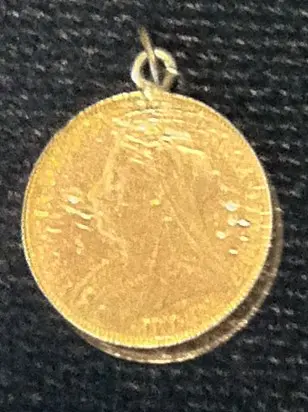 gold medal showing a woman’s head