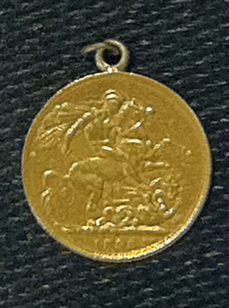 gold medal showing man riding a horse